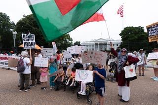 An American-Iranian woman from Tehran, Iran, right, with her US-born children, join a rally outside the White House